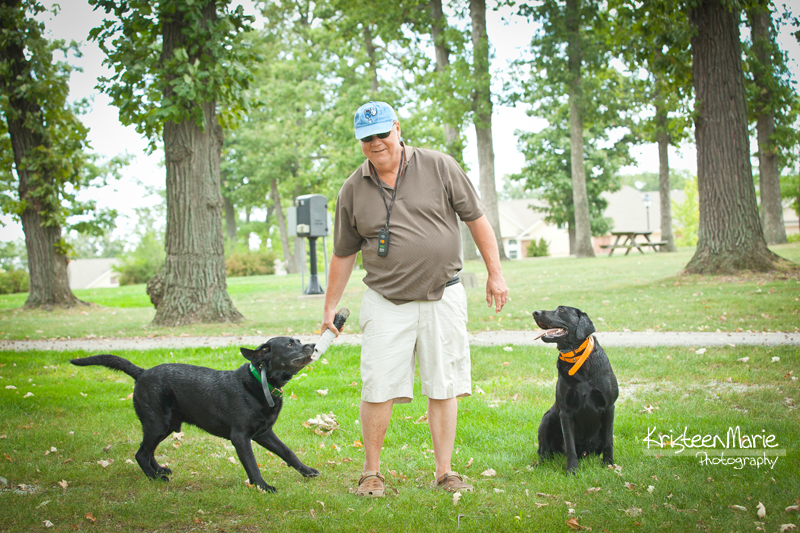 Dad with two black labs