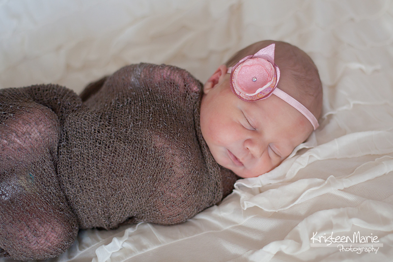 Baby girl in pink, tan, and brown
