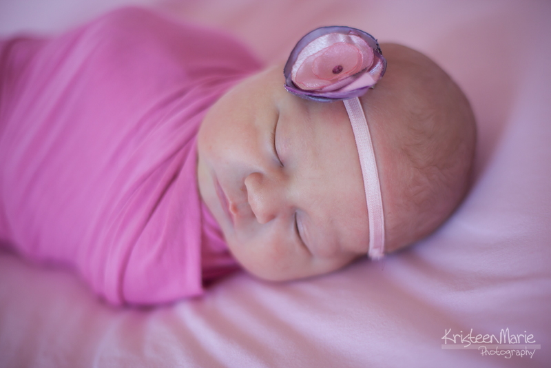 Newborn in pink wrap and hairband