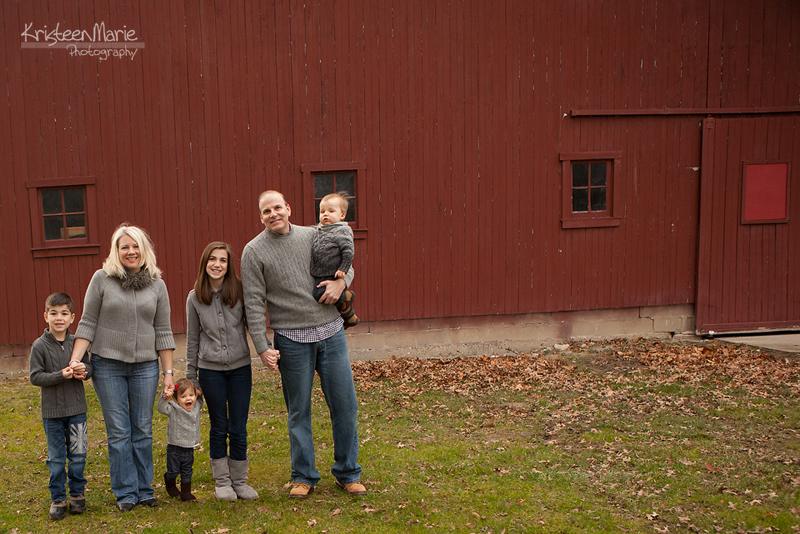 Family of 6 infront of a barn