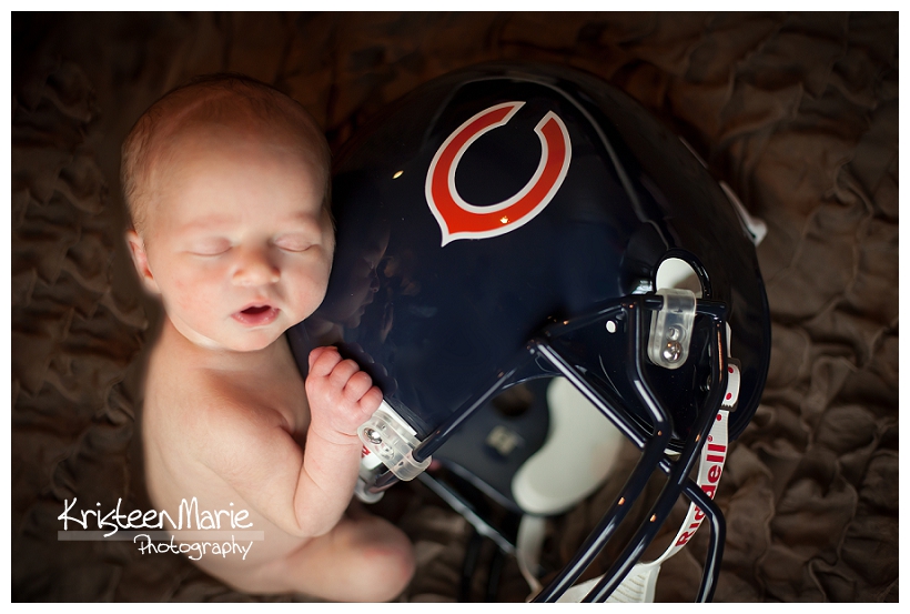 Newborn with Cubs helmet 