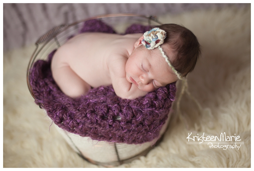 Baby in a basket and purple and cream