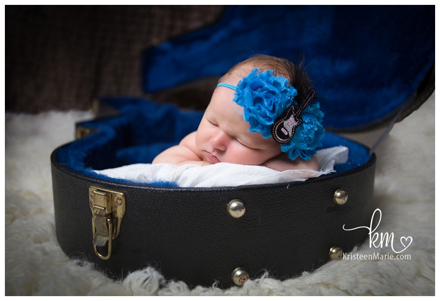 newborn baby girl in guitar case