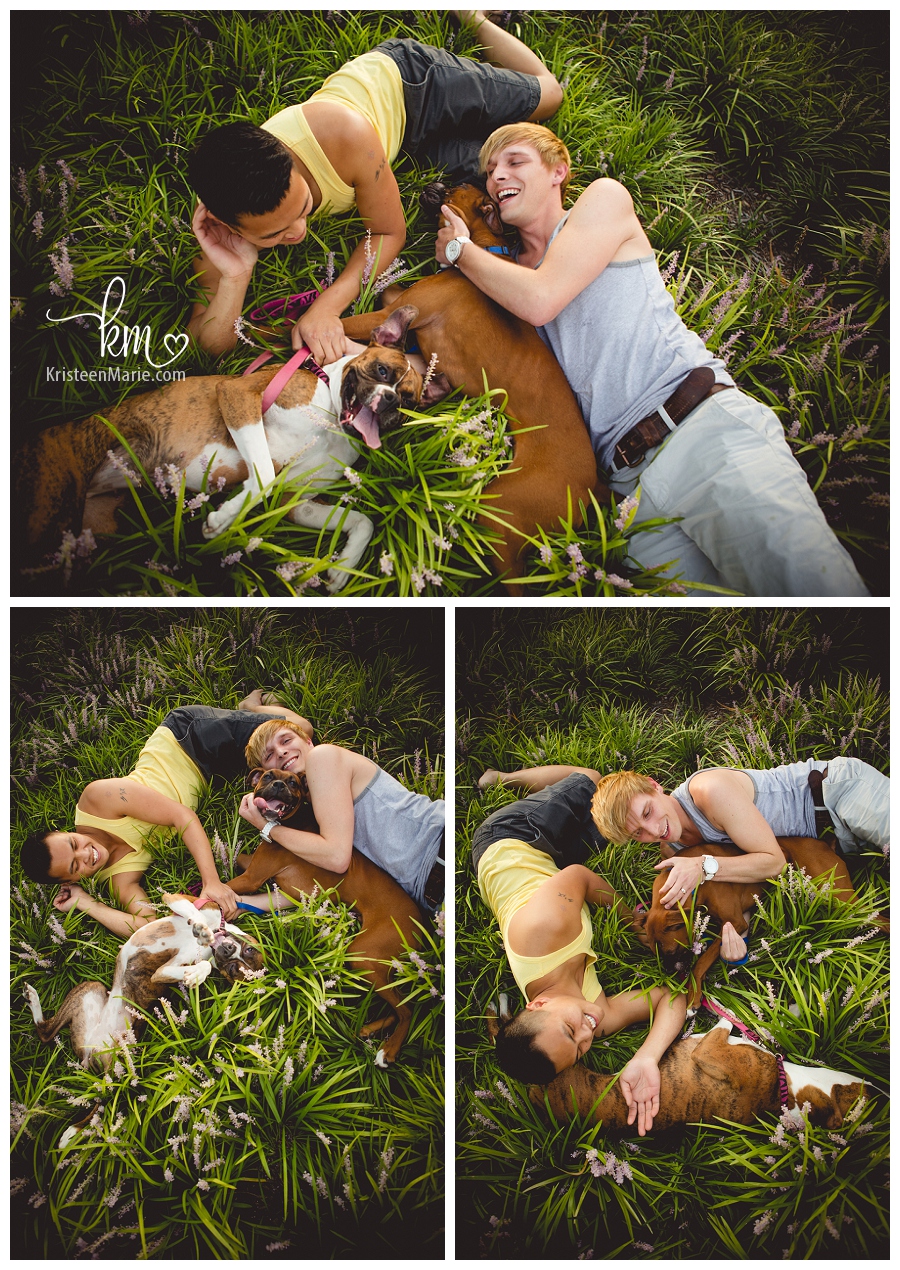 couple cuddling with pups in tall grass