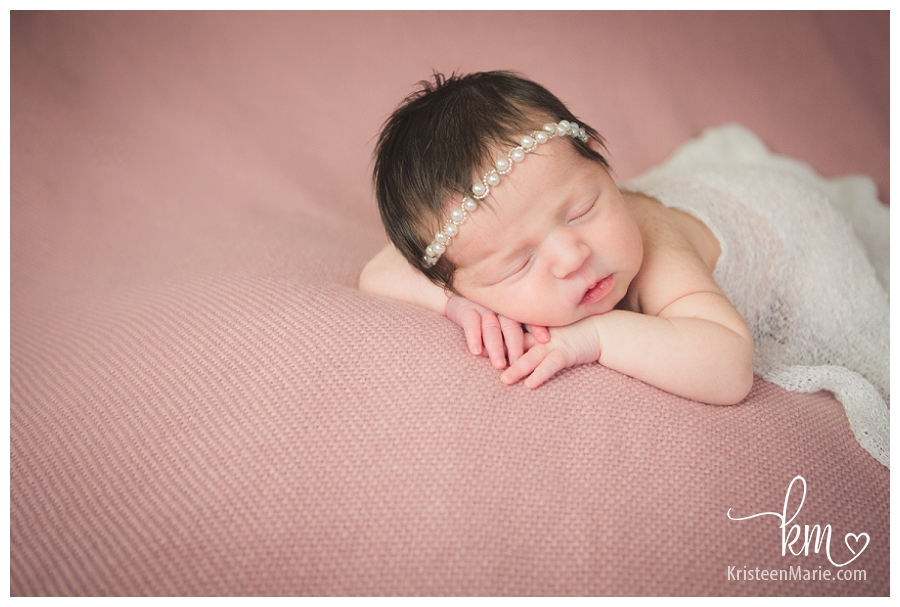 newborn girl sleeping - pink and white pearls