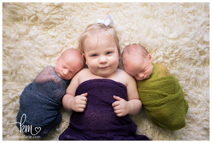 big sister with twin newborn boys