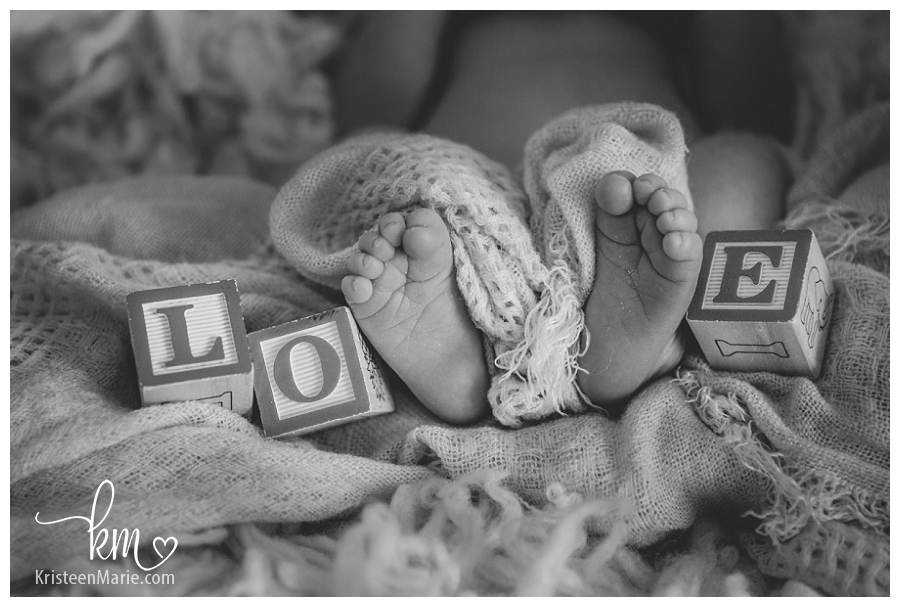 newborn photography with blocks and feet - LOVE
