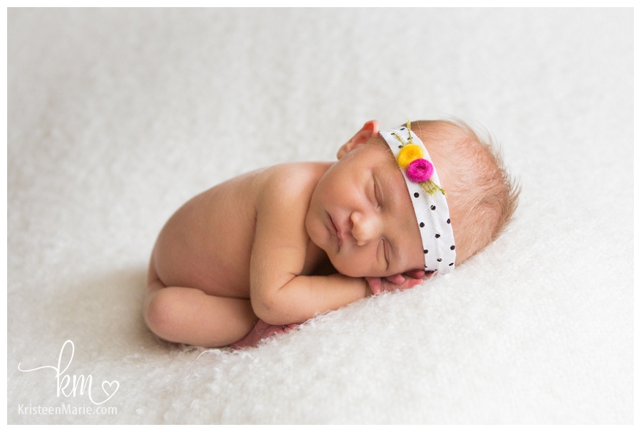 Newborn on white with yellow and pink