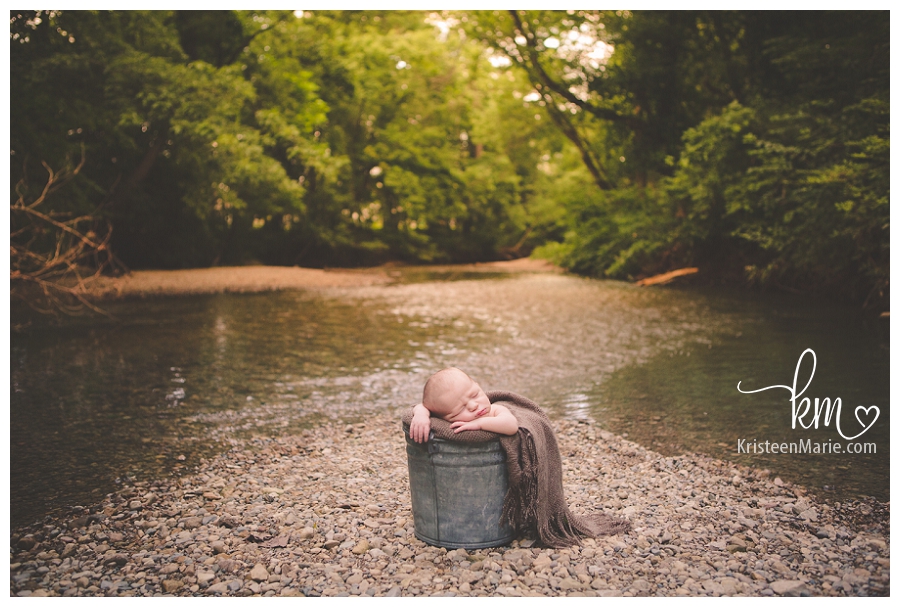 Newborn photography with sun setting on water