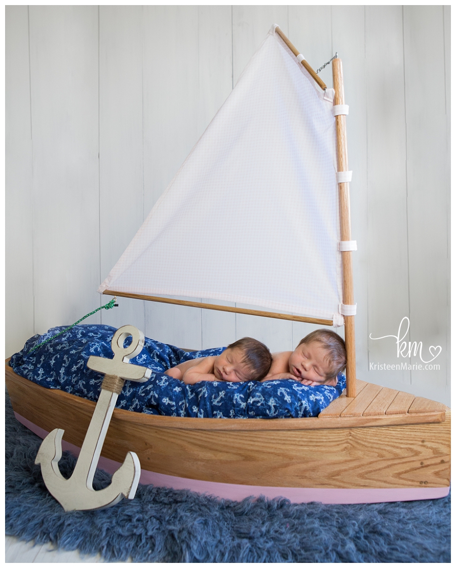 newborns in wood boat prop