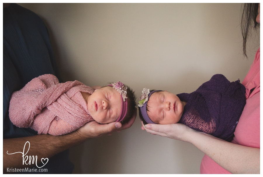 parents holding twin girls