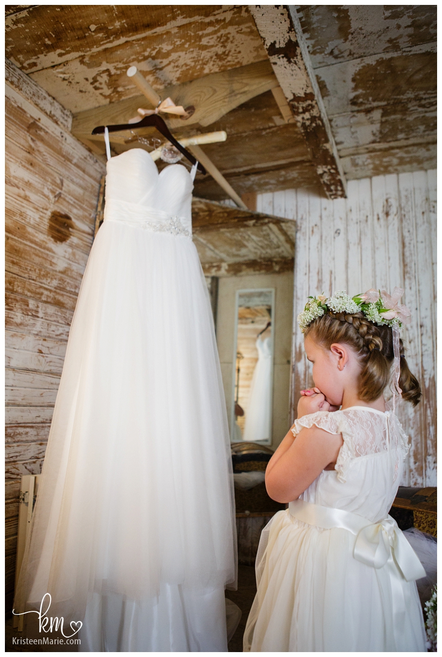 flower girl looking at wedding dress