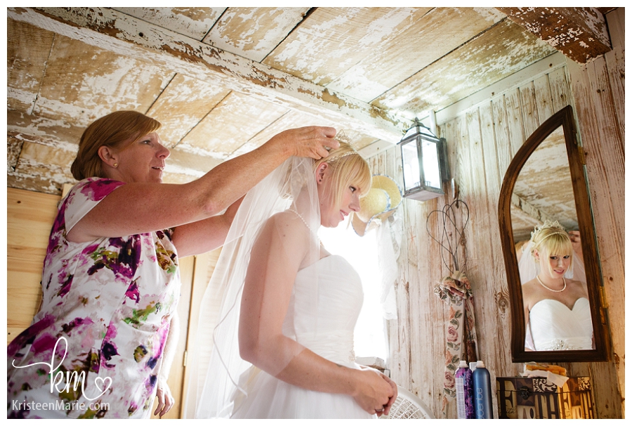 mom helps bride get ready on her wedding day