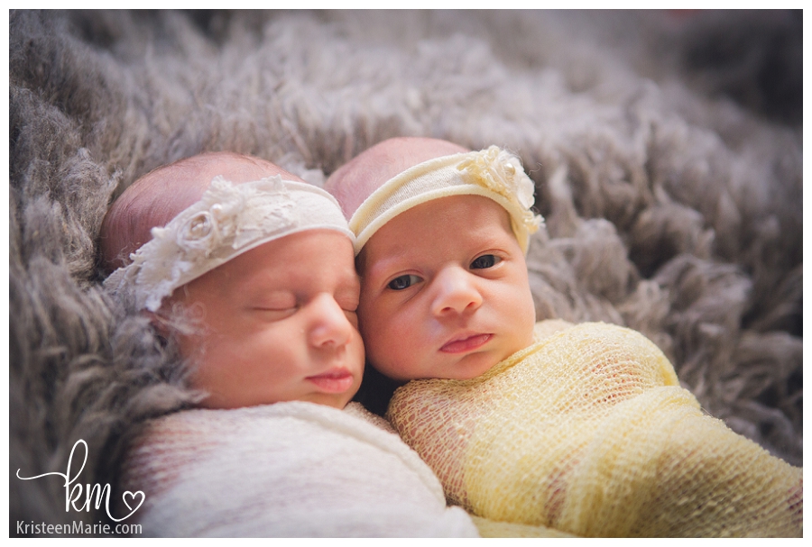 twin newborn girls with one girl awake