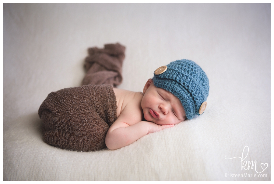 Newborn baby in blue and brown
