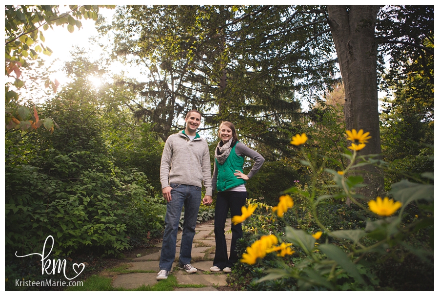 yellow flowers and an engaged couple