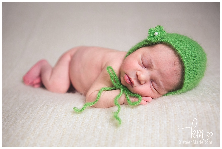 Newborn girl with green bonnet