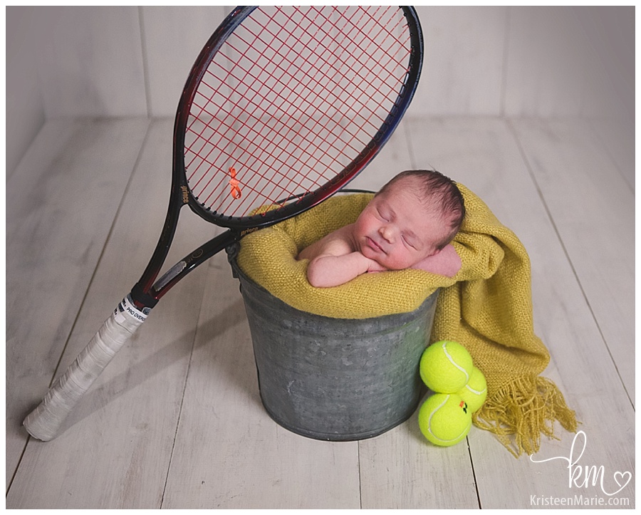 baby girl with tennis equipment