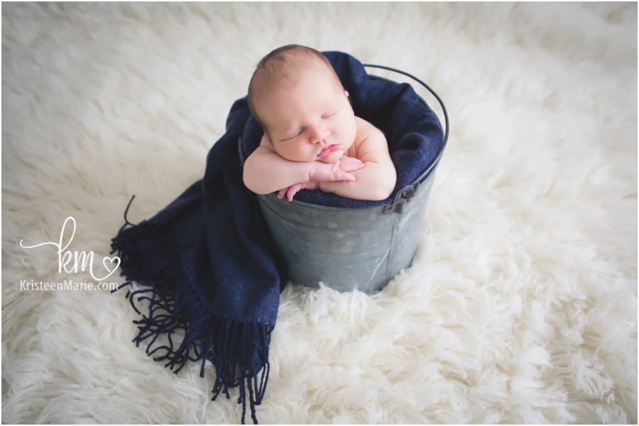 newborn boy in a bucket