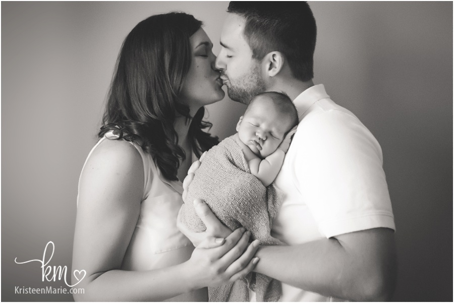 family with newborn baby in black and white