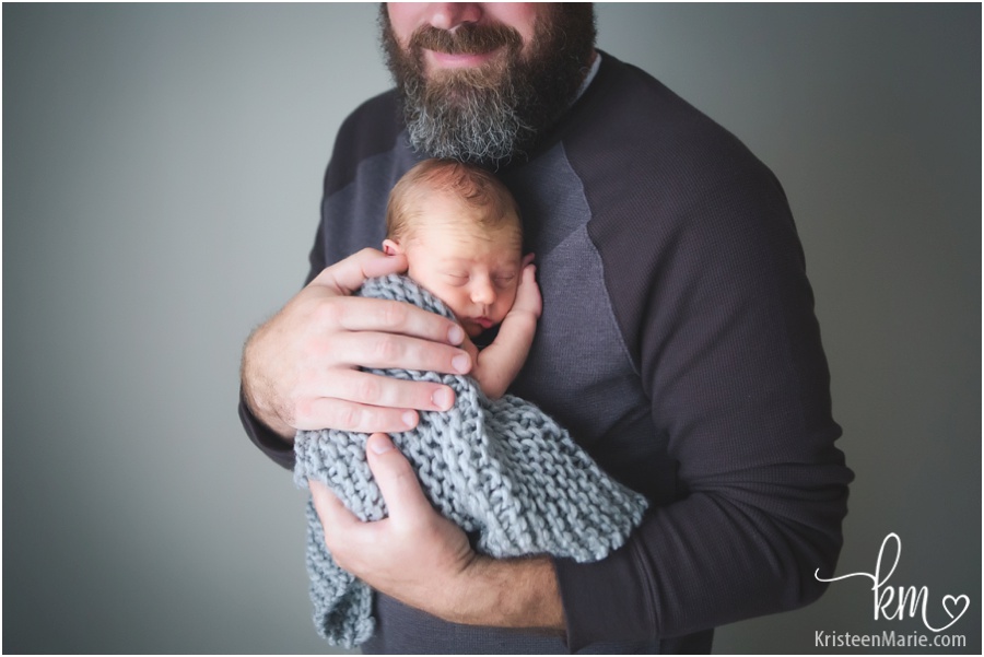 dad and newborn son - father son pose with baby