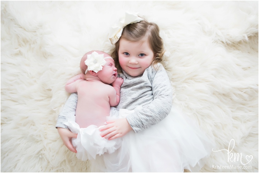 hugs from big sister to newborn baby girl