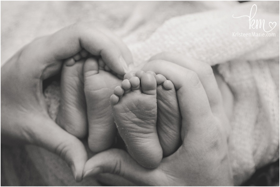newborn twin feet in heart