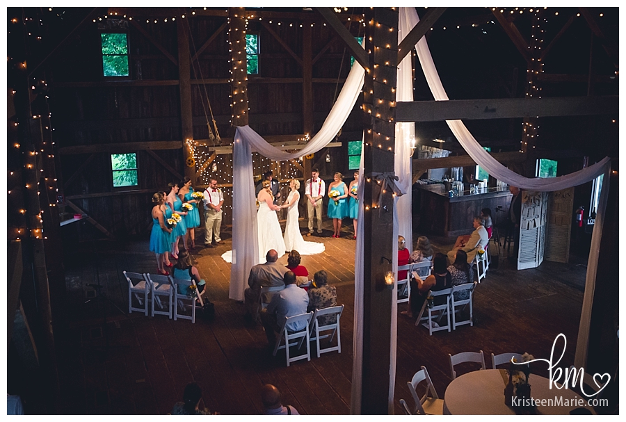 Wedding ceremony inside barn at Mustart Seed Gardens