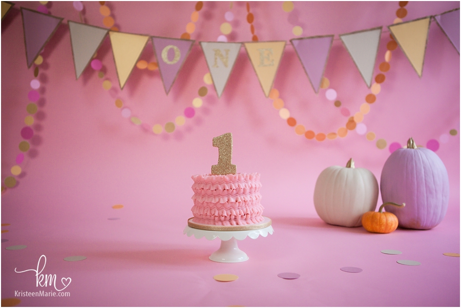 pink and gold cake smash cake with pumpkins