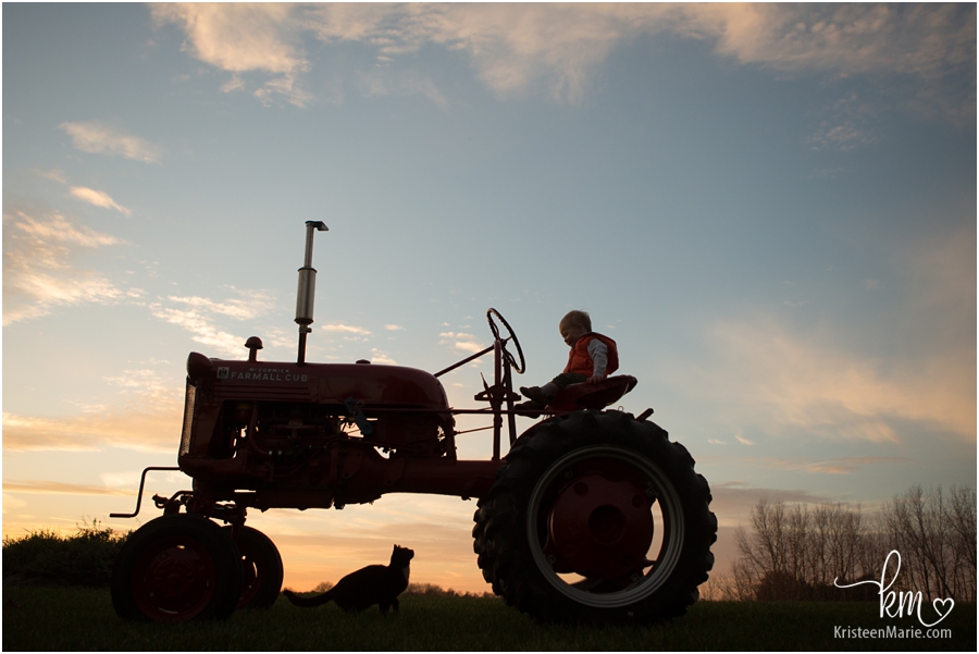 sunset silhouette with boy on tractor - beautiful!!