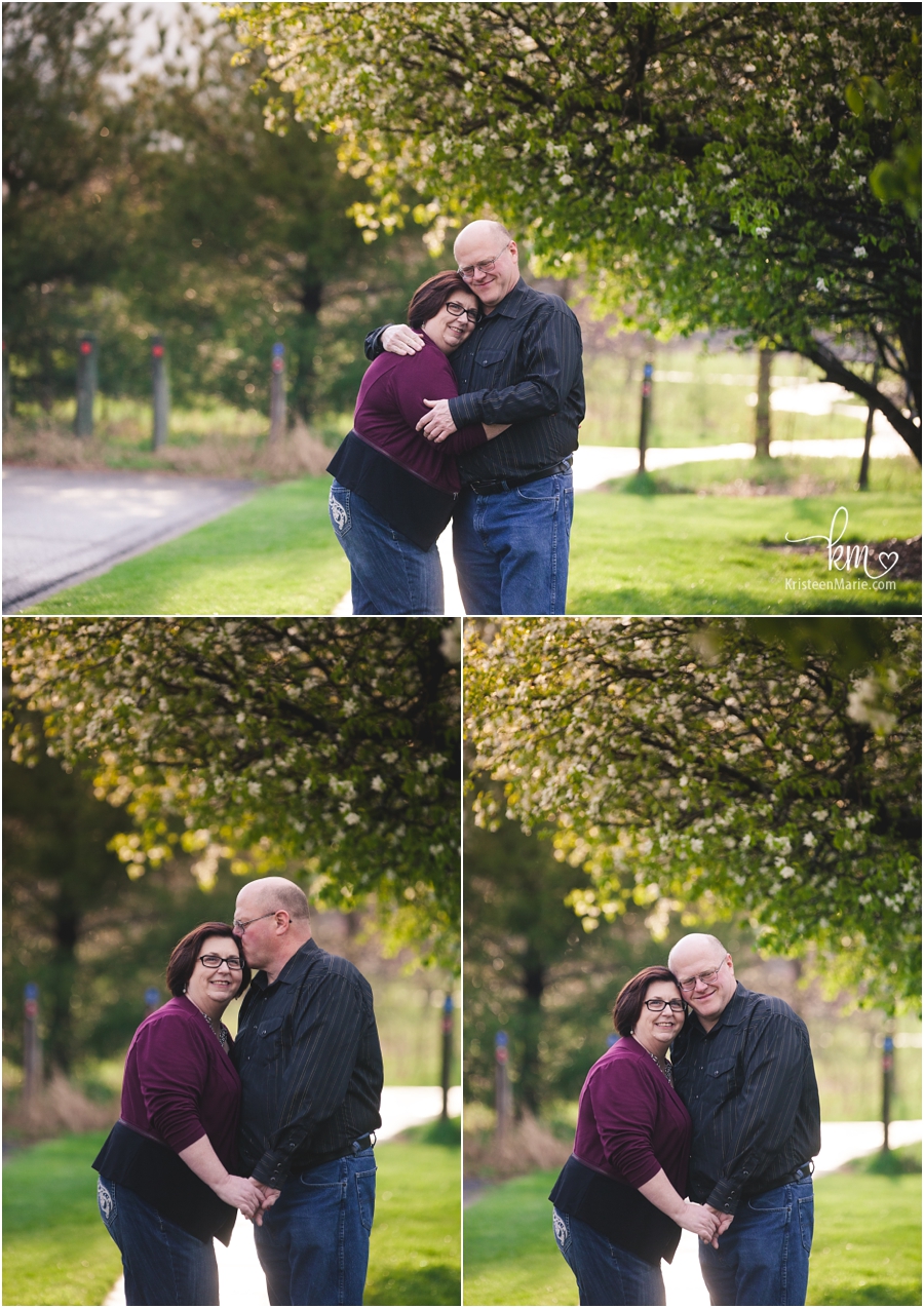 couple hugging under a tree in Indianapolis for engagement pictures