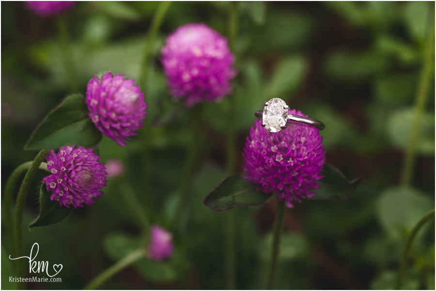 engagement ring and purple flowers