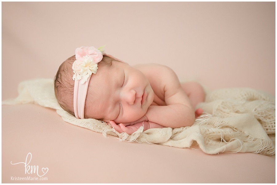 newborn baby girl laying on her side