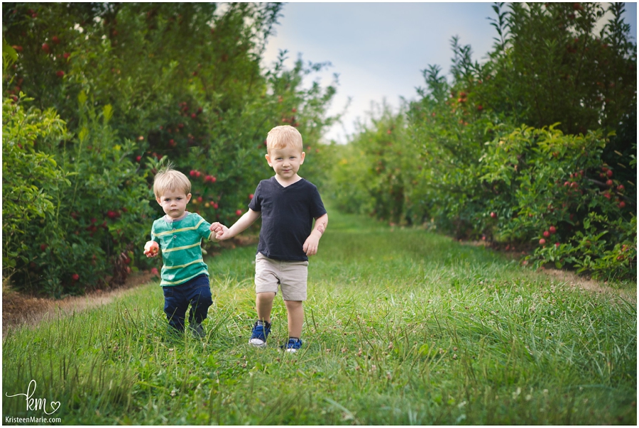 boys holding hands in the orchard