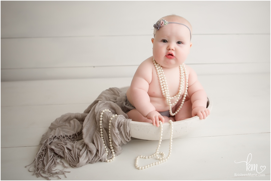 baby in a bowl with pearls