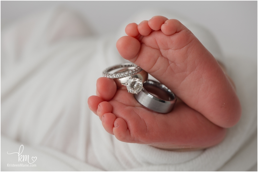 newborn baby feet with wedding ring