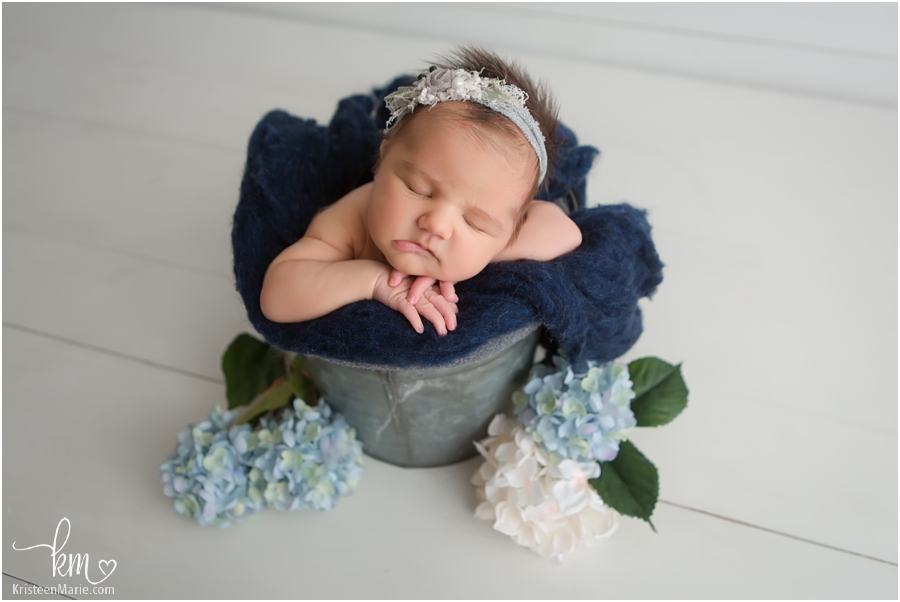newborn girl in a bucket - blue flowers