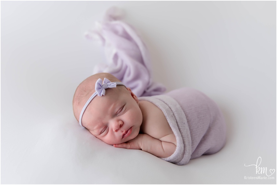 baby in purple on white - Indianapolis newborn photography