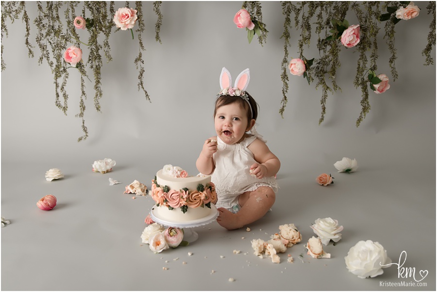 1st birthday cake smash with blush pink flowers and greenery