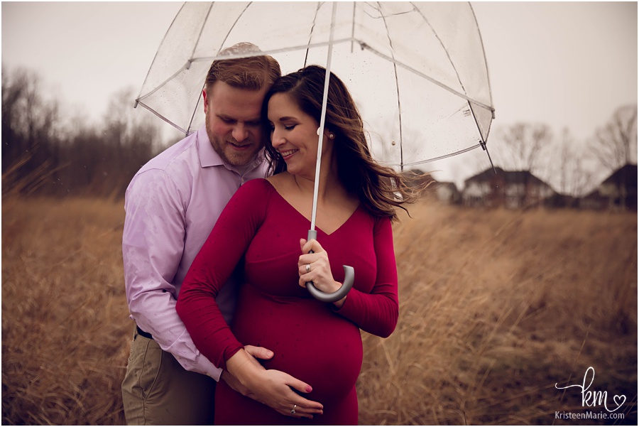 couple cuddled in the rain - maternity session