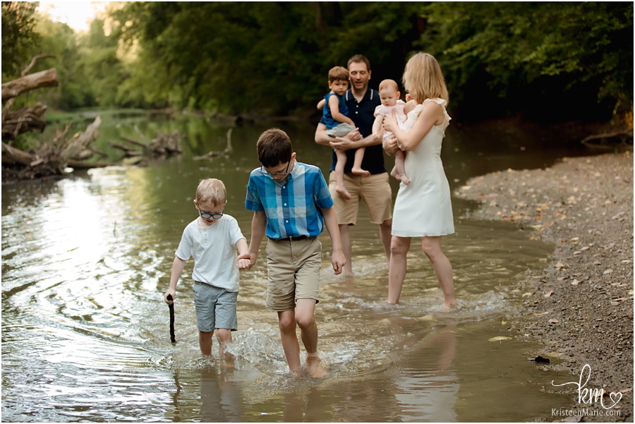 family playing in the creek