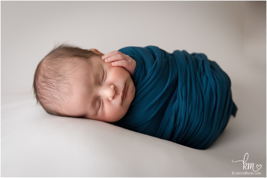warpped newborn boy in blue