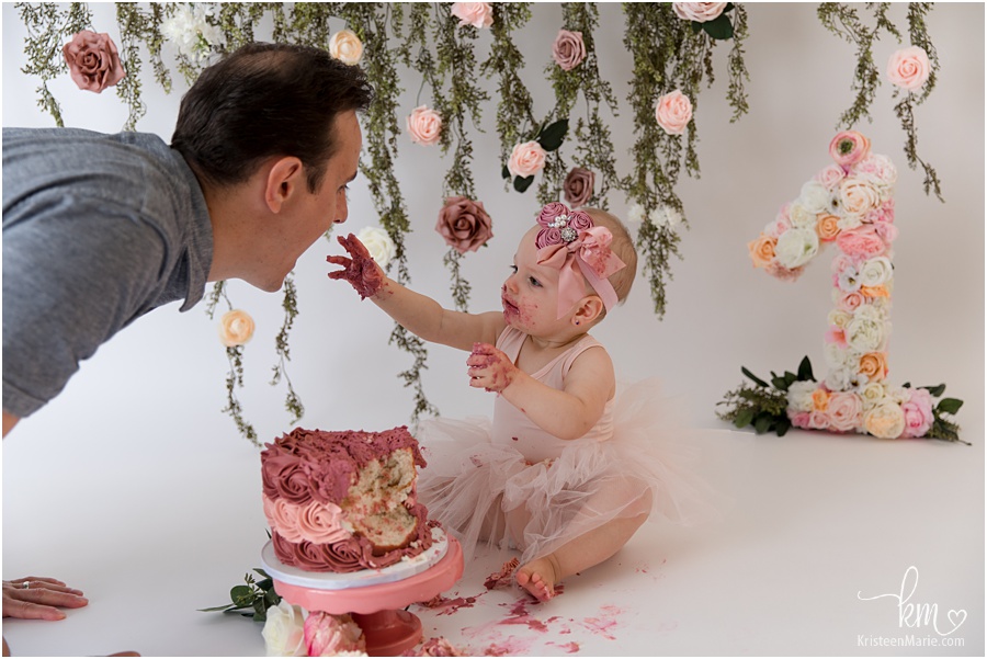 dad and baby eating cake