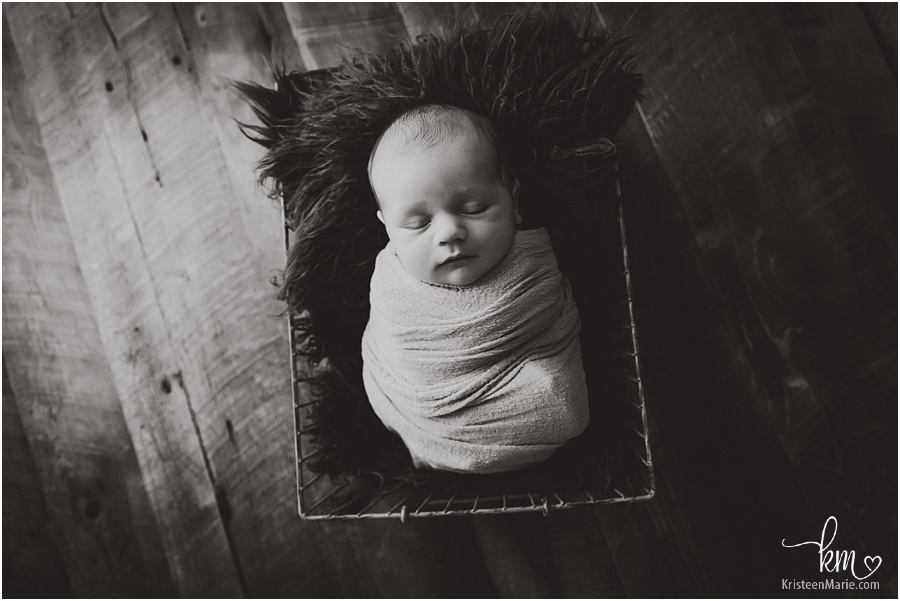 moody black and white newborn photography image