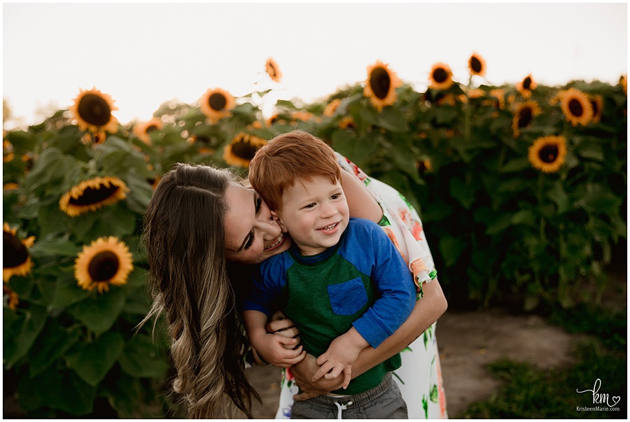 Mother and son in sunflower field