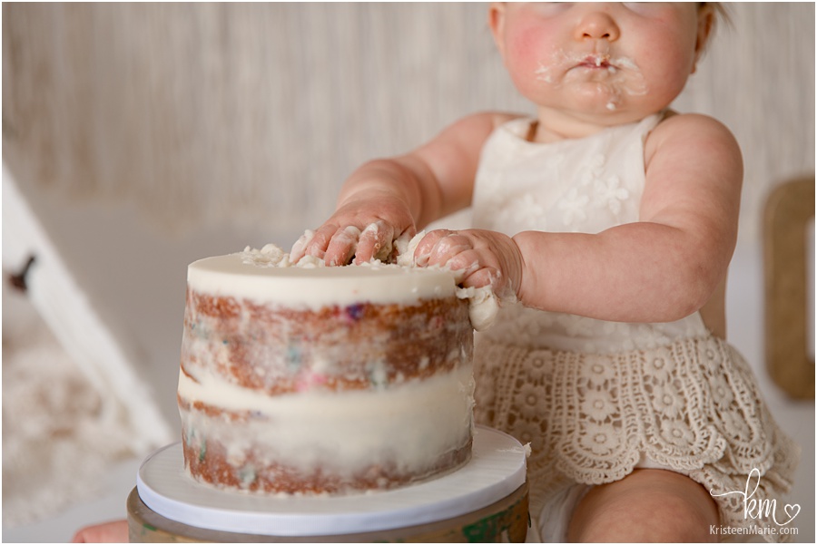 chubby baby fingers eating cake