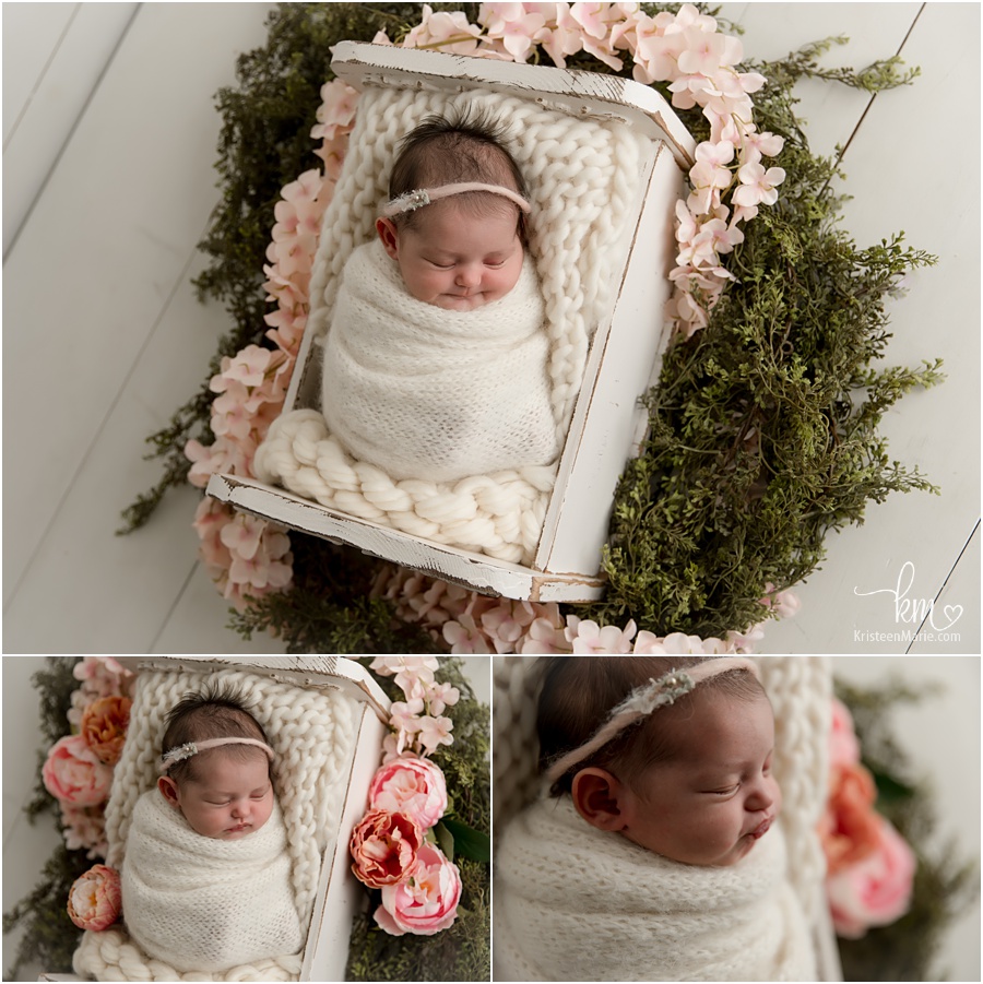 newborn girl with pink flowers set-up
