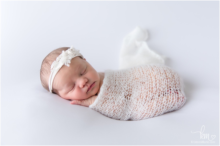 sleeping newborn girl in white