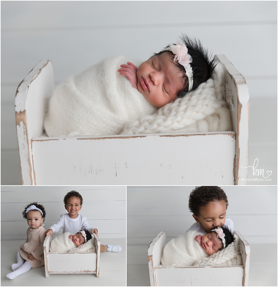 newborn girl in white crib