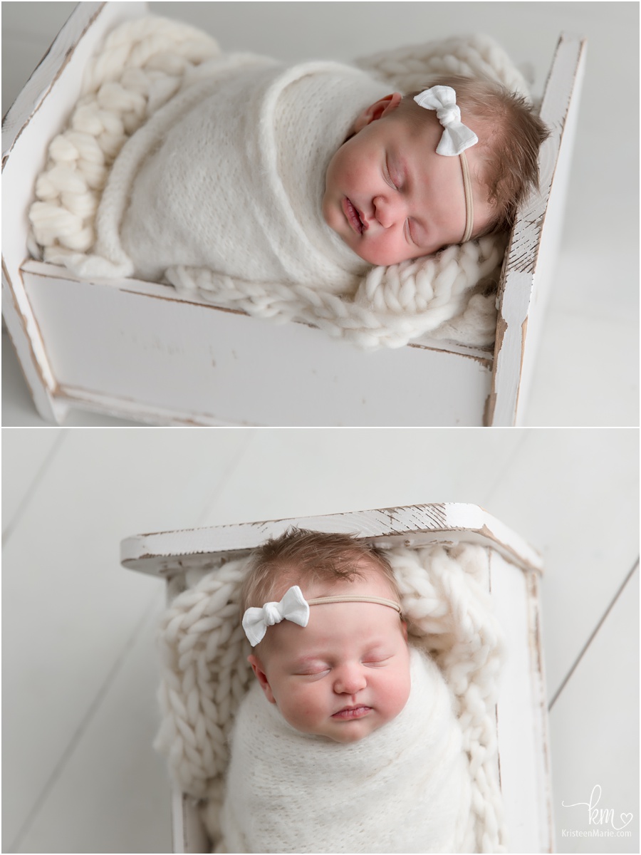 newborn girl with chunky face in box